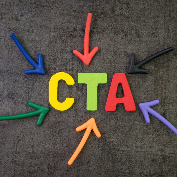 CTA Call to action in advertising and communication concept multi color arrows pointing to the word CTA at the center of black cement chalkboard wall